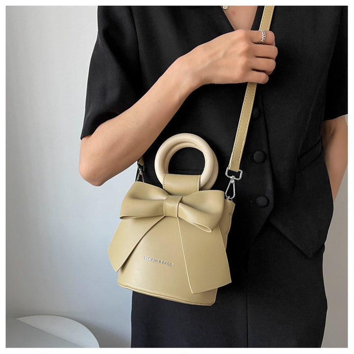 Trendy Bow Crossbody Bag | High-Quality PU Leather Bucket Bag with Wooden Handle Glossy.pk