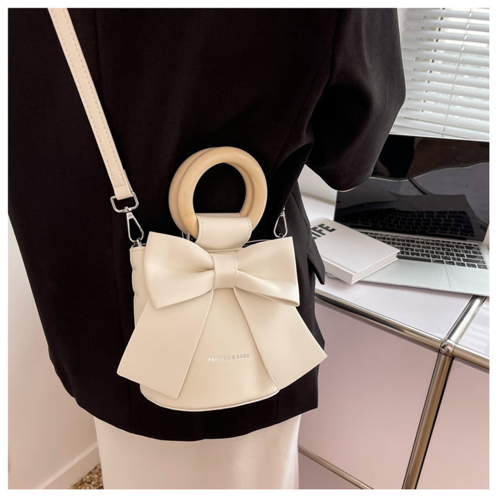 Trendy Bow Crossbody Bag | High-Quality PU Leather Bucket Bag with Wooden Handle Glossy.pk