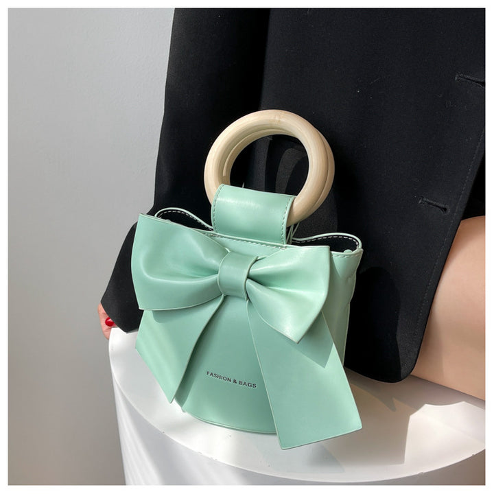 Trendy Bow Crossbody Bag | High-Quality PU Leather Bucket Bag with Wooden Handle Glossy.pk